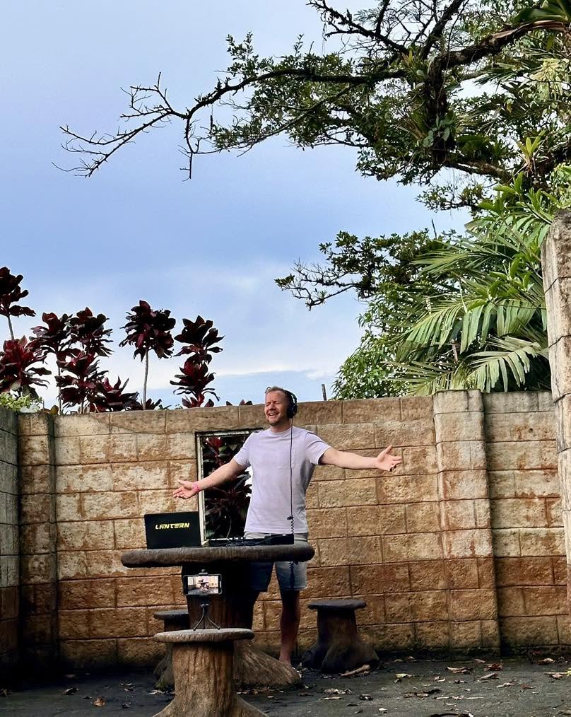 DJ Lantern DJing outdoors in a tropical courtyard